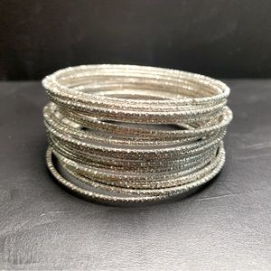 Twenty diamond cut silver bangle bracelets- costume jewelry